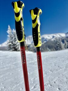 Two ski poles on snowy mountain. One reads Courage, the other, Gratitude.