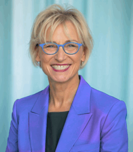 Image of Pamela Meyer, Ph.D. wearing a bright blue jacket and blue glasses.